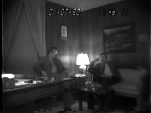 Another frame from the same FBI footage, two minutes later. The release does not identify the men.