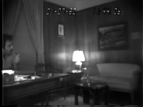 A frame from FBI hidden-camera footage released by the Bureau, stamped on screen 01-07-80. The Senate report places the Murtha meeting in the W Street townhouse on that date; the FBI release does not name who appears.