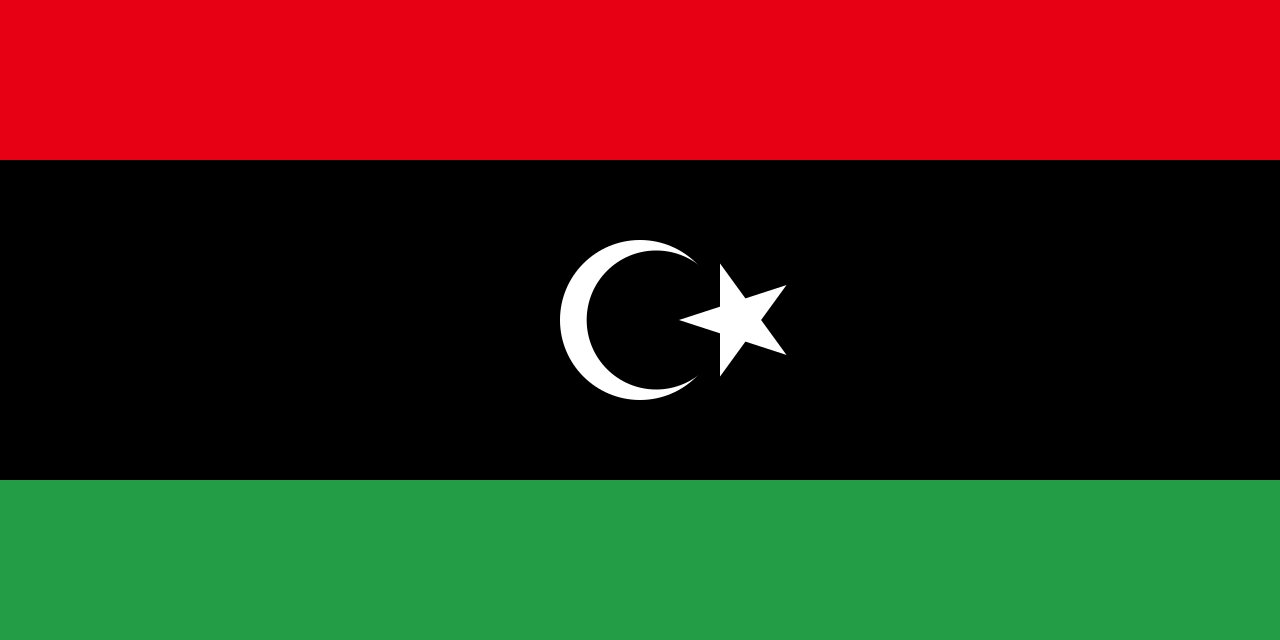 Flag of Libya (post-2011). Typographic/flag stand-in for the post-revolution setting — not a photograph of the compound.