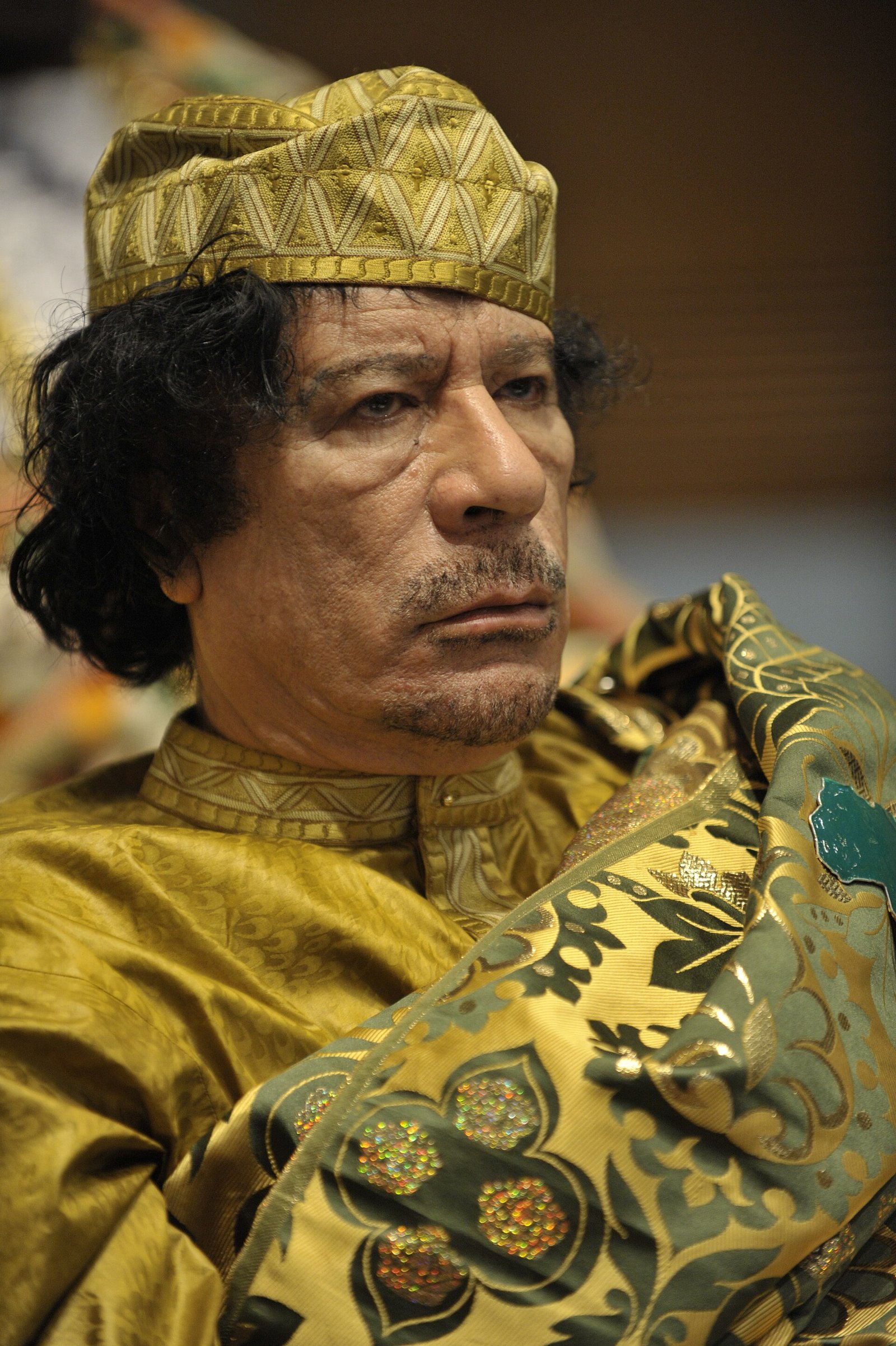 Muammar al-Gaddafi at the AU summit — public domain portrait used for the 2011 joke chapter.
