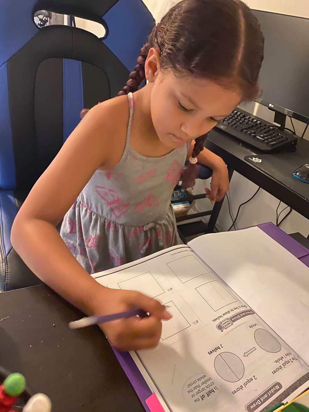 A child works at home during Hawaii school closures, May 12, 2020.