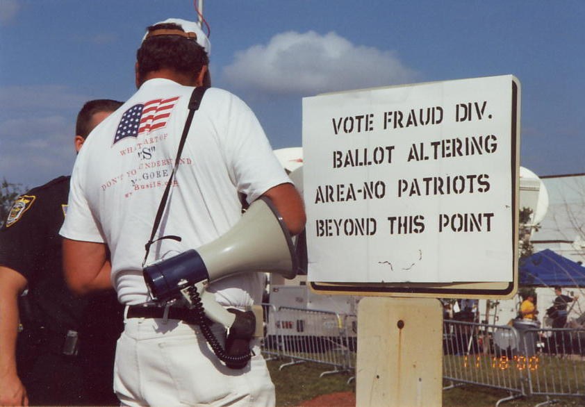A protest sign alleging ballot fraud near the Palm Beach County recount on November 18, 2000; the sign is a claim, not evidence of its truth.