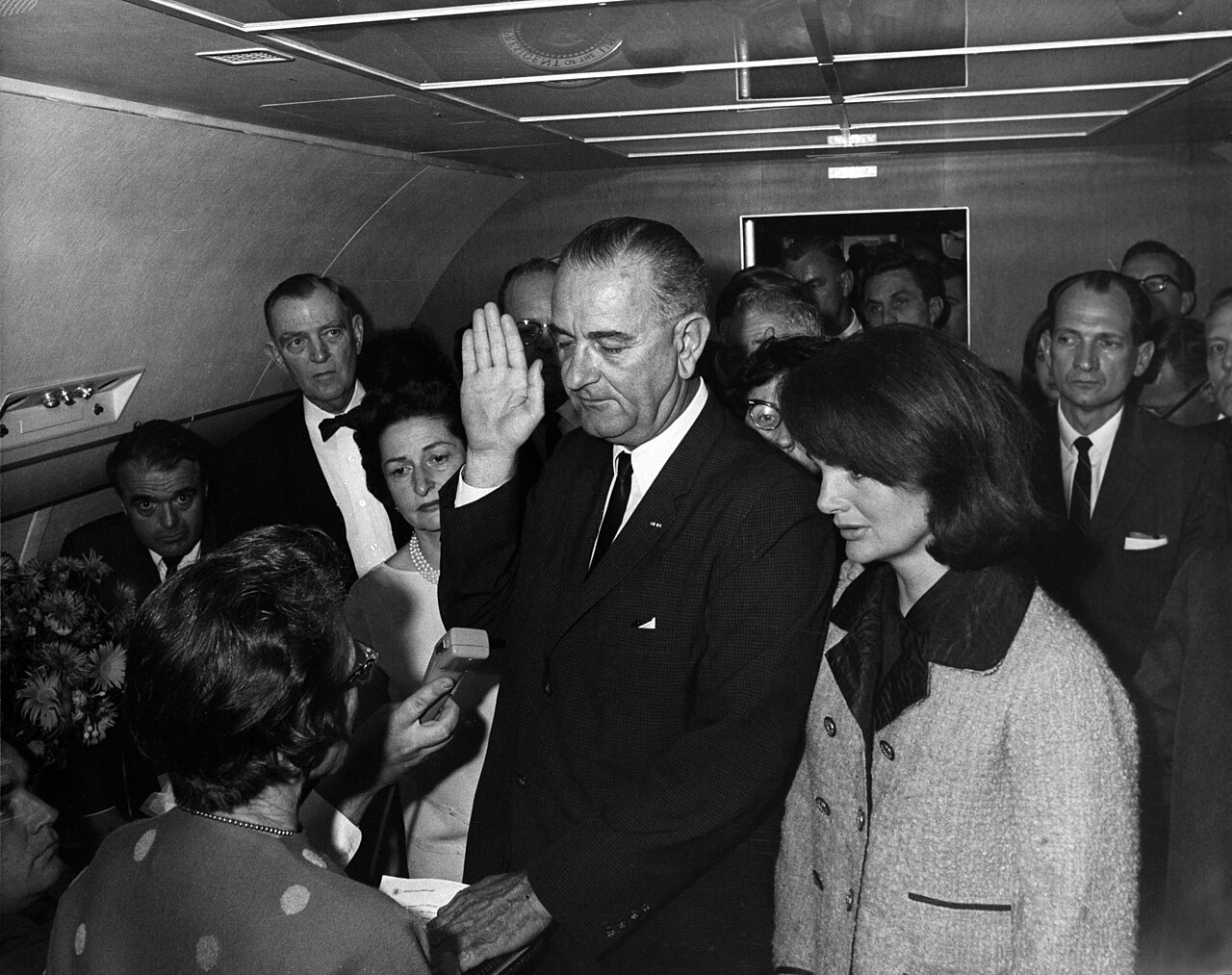Lyndon B. Johnson takes the presidential oath aboard Air Force One, November 22, 1963.