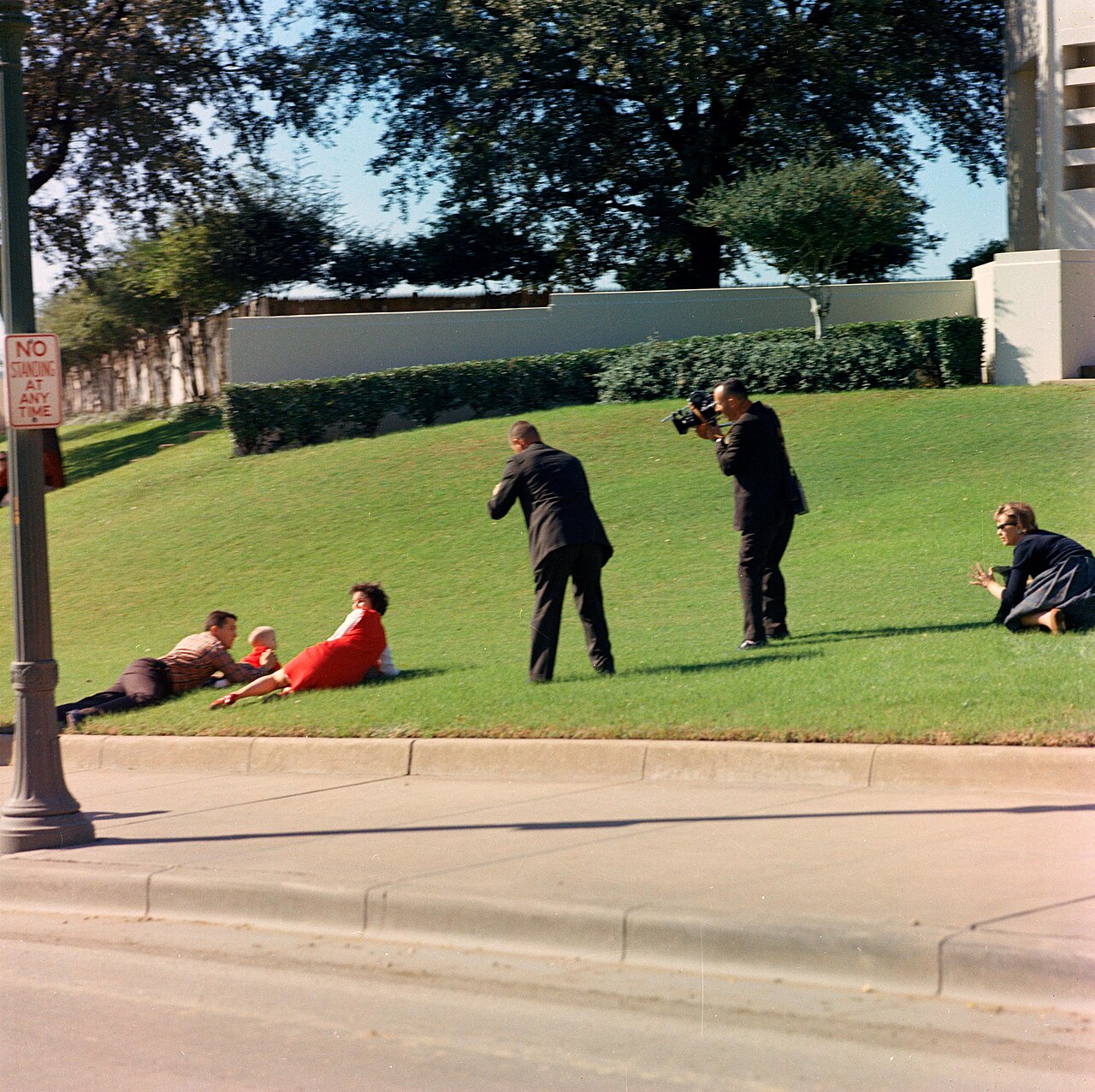 The Newman family shelter on the grass after the shooting, November 22, 1963. This is the White House photographer’s view, not the separately copyrighted news photograph.