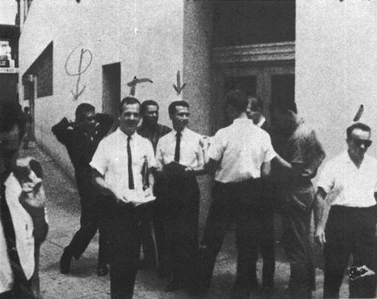 Oswald (right) hands out “Hands off Cuba” leaflets in New Orleans, August 1963. Warren Commission exhibit.