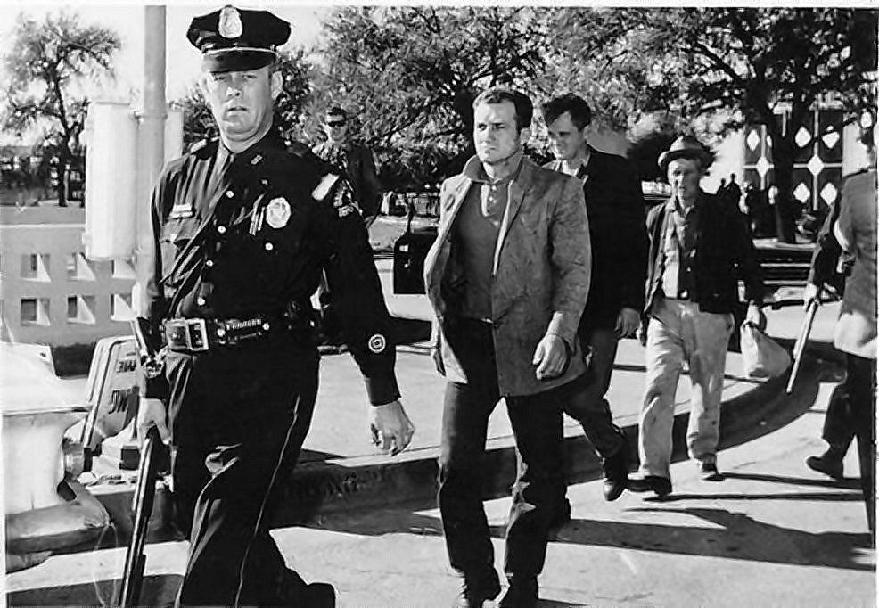 The three men taken from a railroad car behind Dealey Plaza and marched past photographers, 22 November 1963.