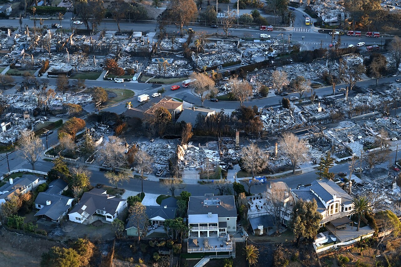 Homes and neighborhoods devastated by the Palisades Fire, January 2025. The military caption dates the scene January 14; camera metadata records January 15.