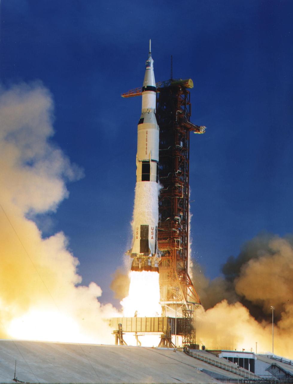 KENNEDY SPACE CENTER, FLA. -- The Apollo 11 Saturn V space vehicle lifted off with Astronauts Neil A. Armstrong, Michael Collins and Edwin E. Aldrin Jr. at 9:32 a.m. EDT July 16, 1969, from Kennedy Space Center's Launch Complex 39A. During the planned eight-day mission, Armstrong and Aldrin will descend in a lunar module to the Moon's surface while Collins orbits overhead in the command module. The two astronauts are to spend 22 hours on the Moon, including two and one-half hours outside the lunar module. They will gather samples of lunar material and will deploy scientific experiments which will transmit data about the lunar environment. They will rejoin Collins in the command module for the return trip to Earth