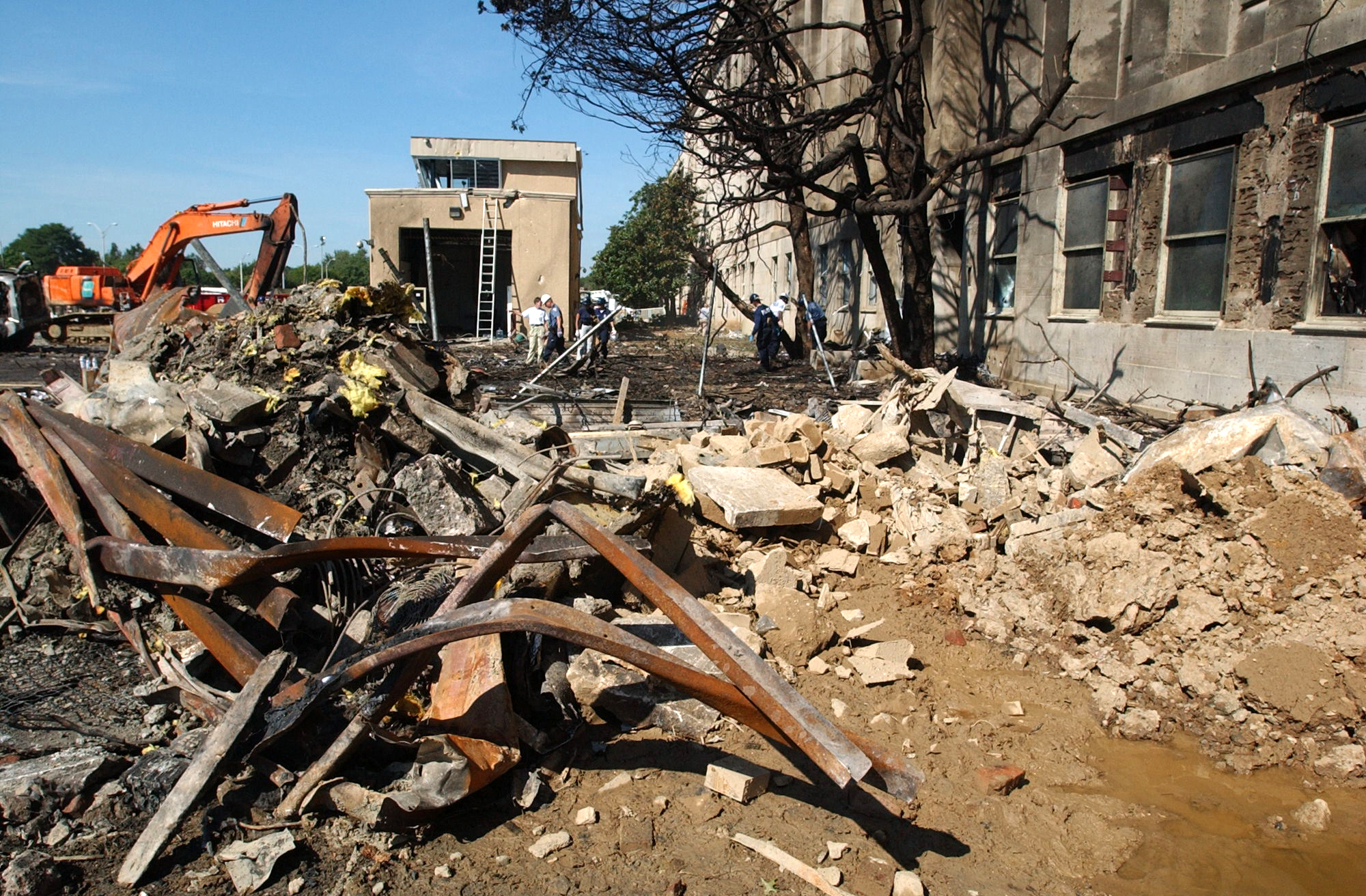 Wreckage and debris on the Pentagon grounds after Flight 77 struck the building. The Navy archive captions this September 12, 2001.