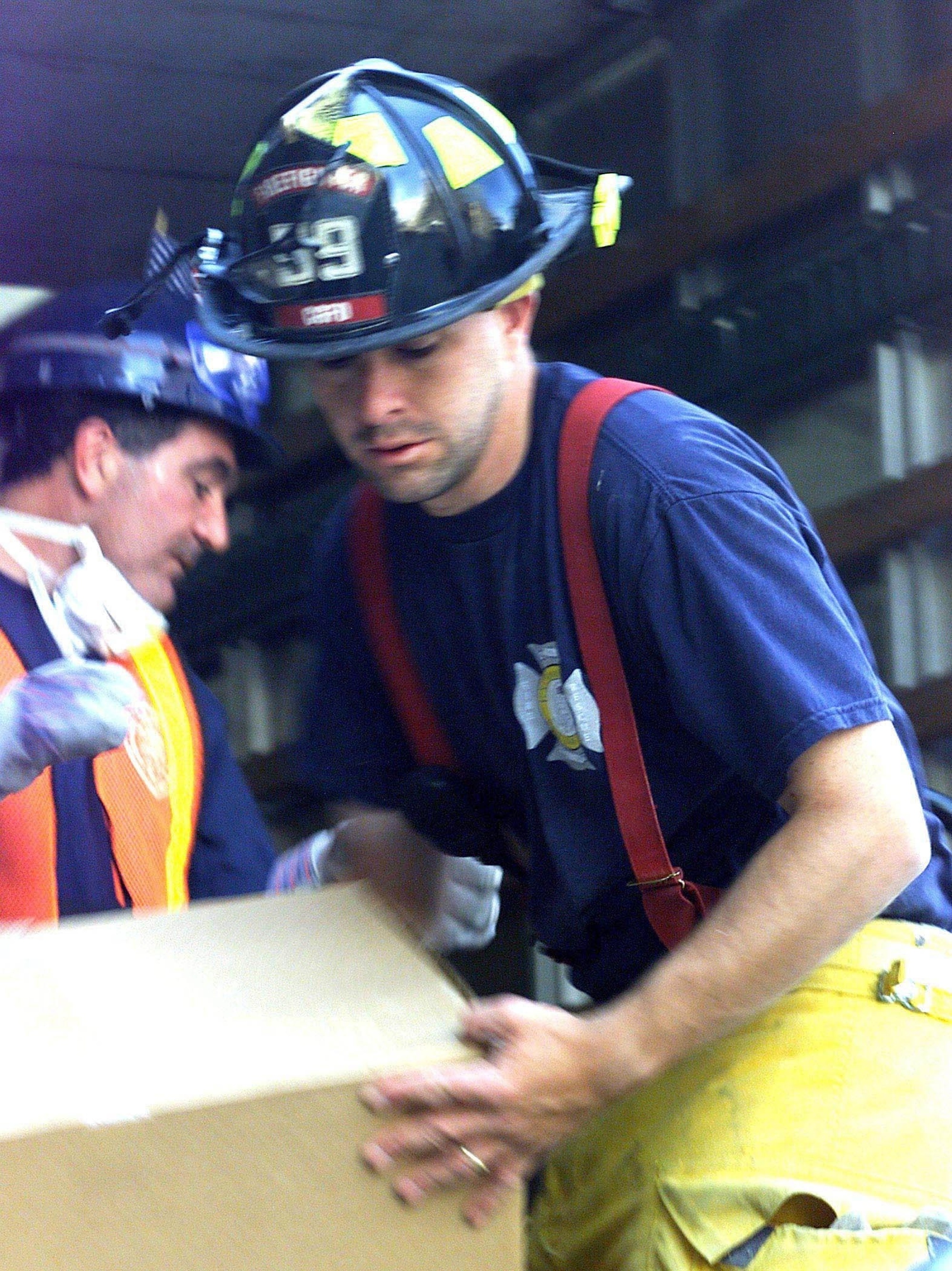 Coast Guard member Michael Guzman unloads donated supplies at Ground Zero, September 17, 2001.