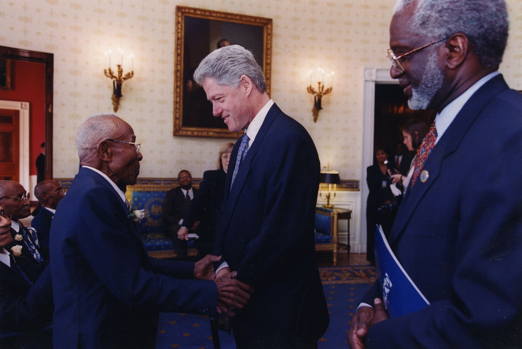 President Bill Clinton greets a survivor of the Tuskegee Syphilis Study on African-American men.